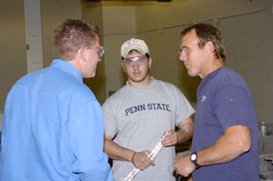 Alumnus Gregory Werstil, left, reconnects with a faculty member and student.