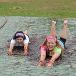 OTA Club President Felicia M. Shoup, of Trout Run (left), and Mariah A. Walter, of New Paris, take a slippery slide across the playing surface.