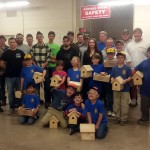 Cub Scouts join their hosts and chaperones in showing off their birdhouses and toolboxes.