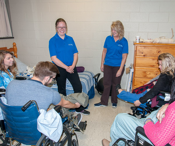 In the occupational therapy assistant lab, students learn how to dress with one arm while in a wheelchair – a skill occupational therapy assistants may teach to clients. 