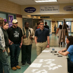 Alger (at center, in glasses) and Miller (seated) staff a question-and-answer table for students.