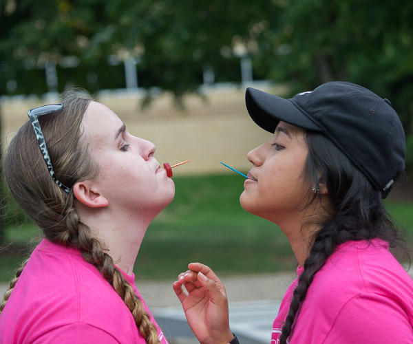 Teammates pass a Life Saver between toothpicks, one of the Wildcat Wars relay events.