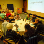 Pens and paper are available throughout the Mountain Laurel Room, as participants are encouraged to record their emotions during the evening's talk.