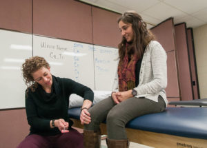 Penn College physical therapist assistant student Kathleen L. Carey, of Montoursville, assesses the deep tendon reflexes of classmate Angela M. Cipolla, of Williamsport, during a practice exercise.