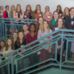 Attendees line a Bush Campus Center stairway for an "awesome" group photo. 