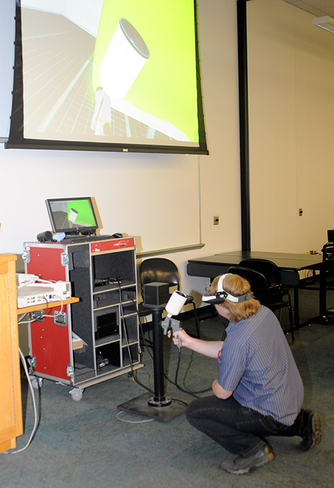 While faculty member Shaun D. Hack provided explanatory commentary, automotive restoration student Andrew J. Graham, of Nicholson, wielded the virtual paint-sprayer ...