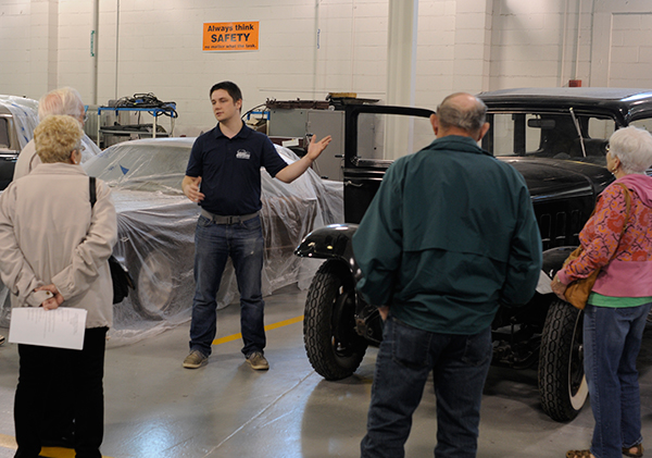 Sean M. Hunter, of Livingston, N.J., knowledgeably leads an AACA tour group through the College Avenue Labs automotive restoration facilities.