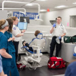 Emergency medical services student Ian P. McClure, of Littlestown, and paramedic technician student Megan E. Bobby, of Dysart, explain the actions they would take when called to the Dental Hygiene Clinic to help a patient experiencing an allergic reaction to Novocain.