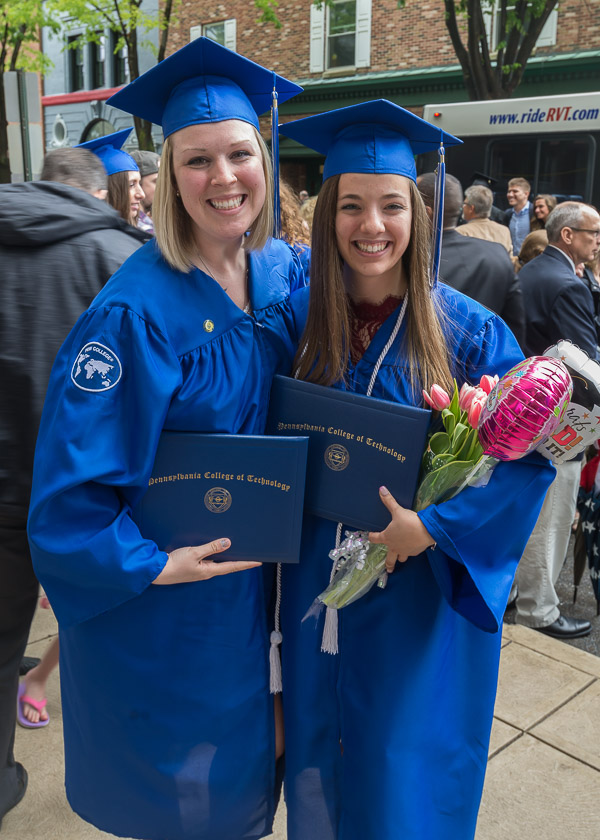 Dental hygiene: health policy and administration concentration grads Kayla C. Summerson (left) and Rebekah L. Caretti celebrate the big event – AND the latter's 21st birthday – on Saturday.