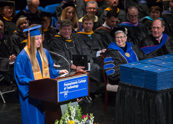 Faculty and administrators lend a collective and attentive ear to Carts, the student speaker for the weekend's second commencement.