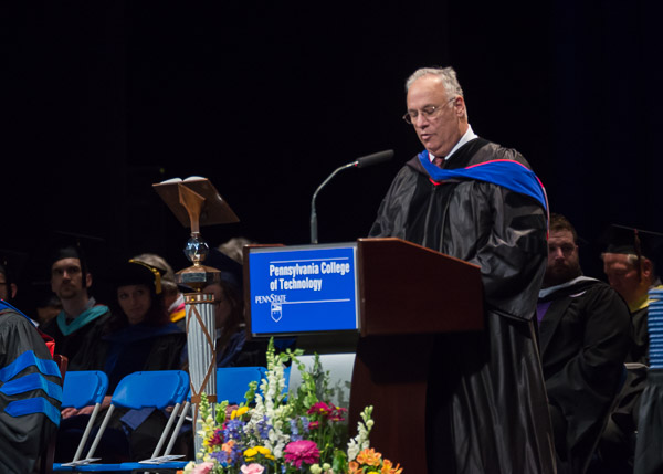 Michael DiRaimo, the newest member of the college board of directors, authorizes the conferring of degrees at Saturday afternoon's ceremony.