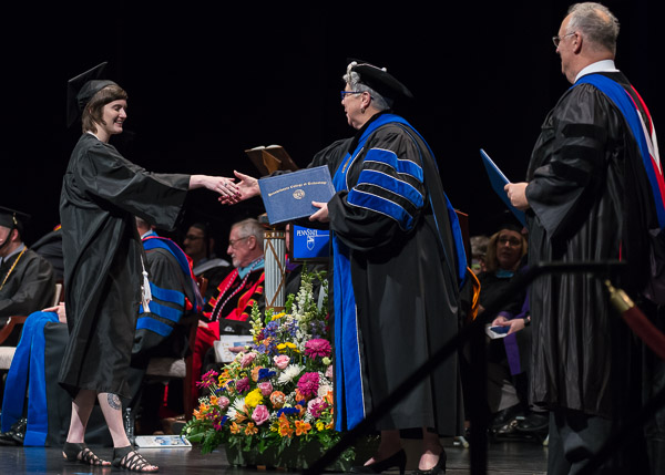 Dalaney T. Vartenisian is congratulated by the president for earning her bachelor's in web and interactive media.