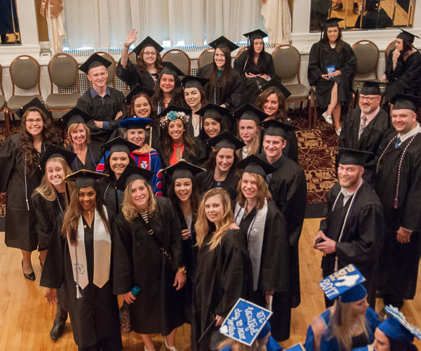 Candidates for bachelor’s degrees in nursing gather around Sandra L. Richmond, director of the nursing program, before the morning ceremony.