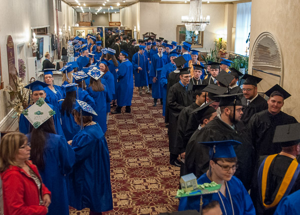 Because of a steady drizzle outdoors, students line up inside the hotel.