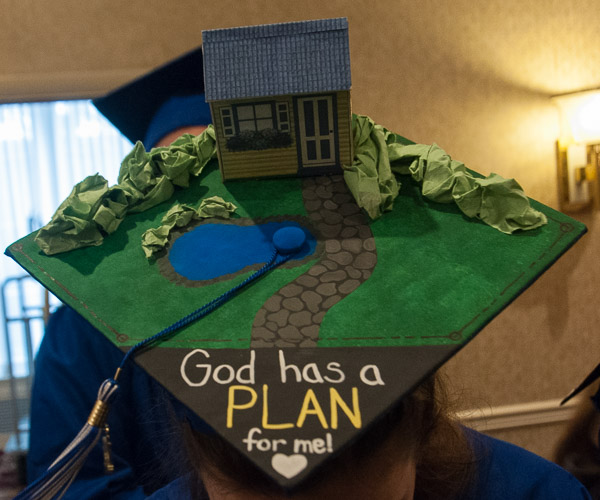 Noting that she likes puns, architectural technology grad Ariana N. Daub, of New Columbia, matches a major-appropriate site plan with her cap’s sentiments.