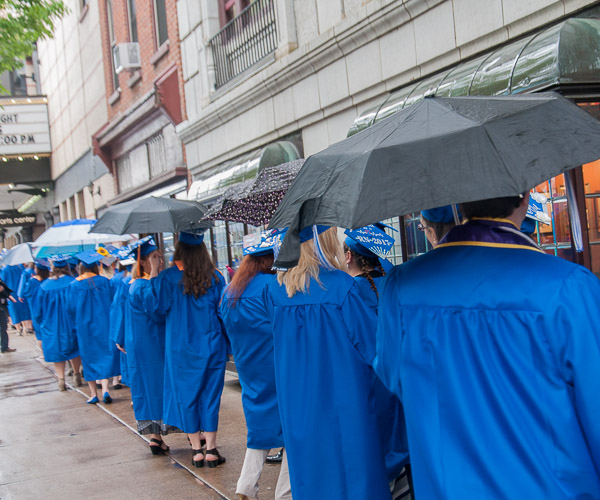 A healthy supply of umbrellas, some courtesy of the Registrar’s Office, helps to keep morning marchers dry.