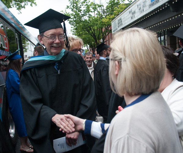 Richard C. Taylor, associate professor of plumbing and heating, greets the family of one of his newly graduated students.