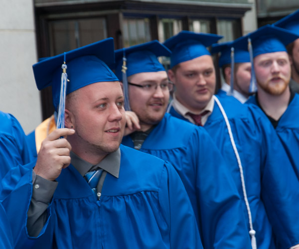 Grads turn their attention to the street as a passing vehicle “honks” its congratulations.