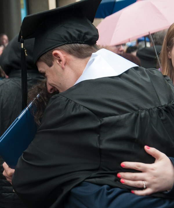 Bryan M. Behm, a student leader from Fleetwood and recipient of the Aviation Faculty Award, hugs a loved one.