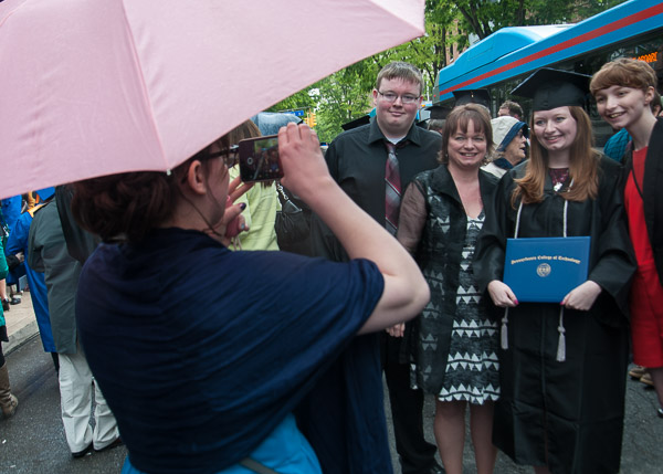 An umbrella keeps the phone dry for a family photo.