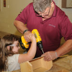 Bella helps craft a keepsake.