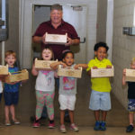 The dean and his morning construction team show off their assembly-line output.