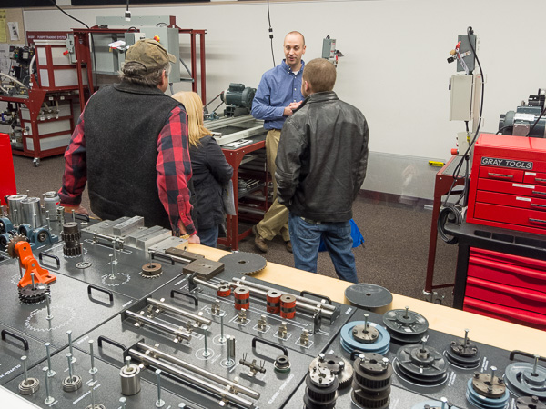 Kevin Yokitis, instructor of electrical technologies and occupations, talks with a prospective student and his family in one of several labs where electronics and computer engineering technology students apply hands-on learning to theory.