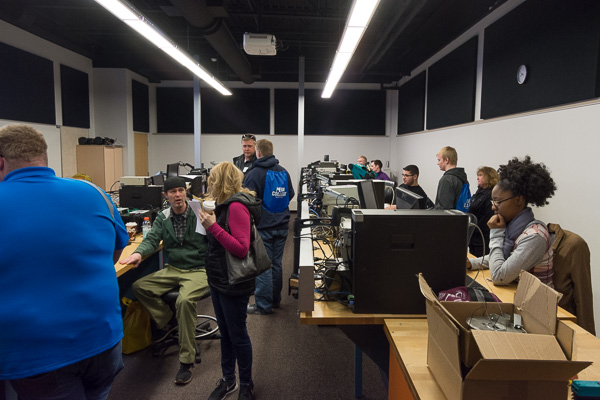 Electronics and computer engineering technology students talk with visitors about their projects. 