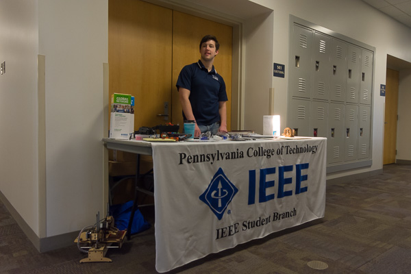 Electronics and computer engineering technology student Norman C. Sabin, of Williamsport, staffs a table for the college’s IEEE student chapter. IEEE is a worldwide professional organization for engineering, computing and technology professionals.