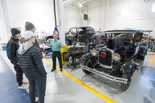 Charles E. O’Brien, a Penn College police officer, talks with visitors about the 1929 Ford Model A coupe he restored with advice from the college’s automotive restoration faculty.