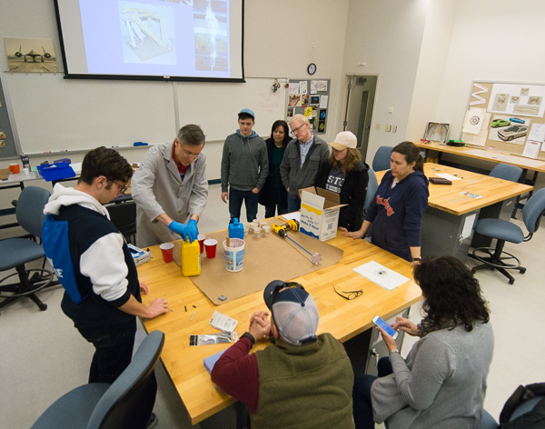 In the industrial design lab, Professor Thomas E. Ask shows off the college’s hands-on component by mixing and pouring resin so that visitors can make molds.