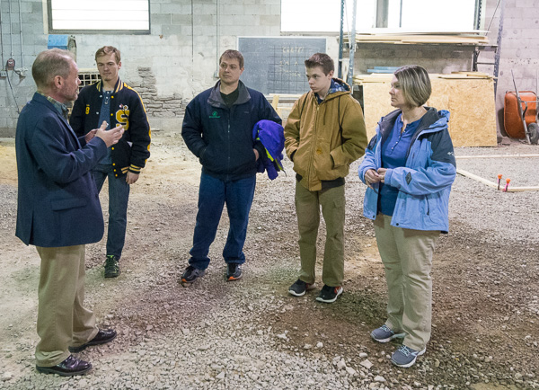 Barney A. Kahn, instructor of building construction technology, walks a family through the concrete masonry lab.