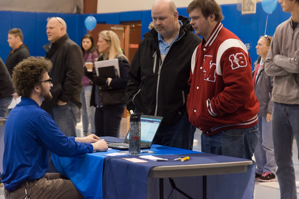 Welding and fabrication engineering technology student Nathaniel H. Lyon, of Fredericksburg, engages prospective students with a friendly face during the check-in process.