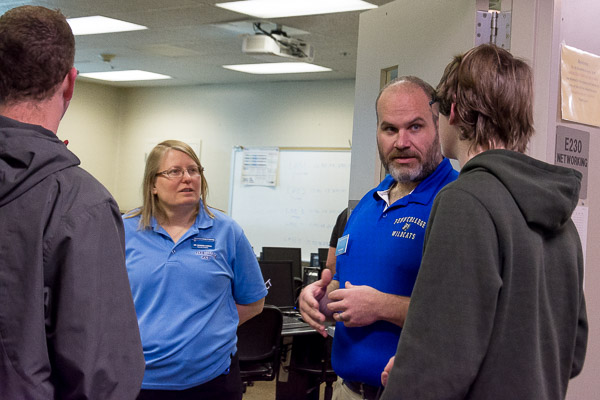 Sandra Gorka, associate professor of computer information technology, and David A. Becker, instructor of information technology, talk with a prospect.