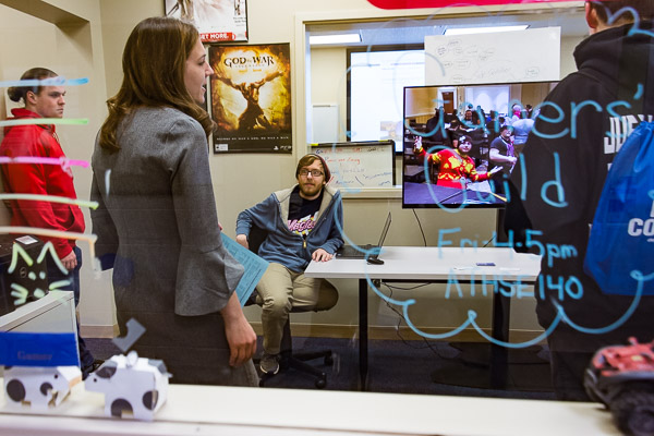 Alicia McNett, instructor of computer information technology, chats with visitors who are interested in gaming and simulation.