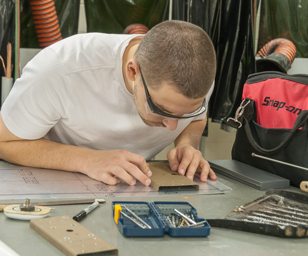 Ross E. Lapides, an aviation maintenance technology student from Saint Johns, Fla., works on his senior project, building a new antenna structure that will place antennas parallel with the airstream.