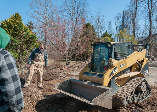 In another display of hands-on learning, Michael A. Dincher, assistant professor of horticulture, leads students in a landscaping project at the Earth Science Center. On Saturday, the students removed a portion of a stone wall and continued to dig out clay soil that retained excess moisture. The new landscape design will include a walkway and seating area.