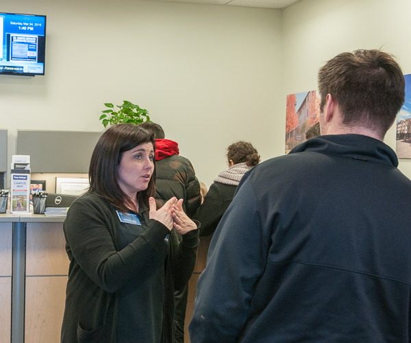 Ashley M. Lyons, secretary to residence life, talks with a prospective student in Dauphin Hall.