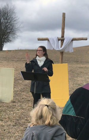 VanBuskirk signs for an appreciative Easter audience, going beyond direct translation to interpret the song's meaning for the congregation.