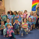 Assistant group leader Valerie L. Vonada (left) and group leader Linda S. Dellaquila (right) bookend the fashionable children "flying on" to kindergarten in August.