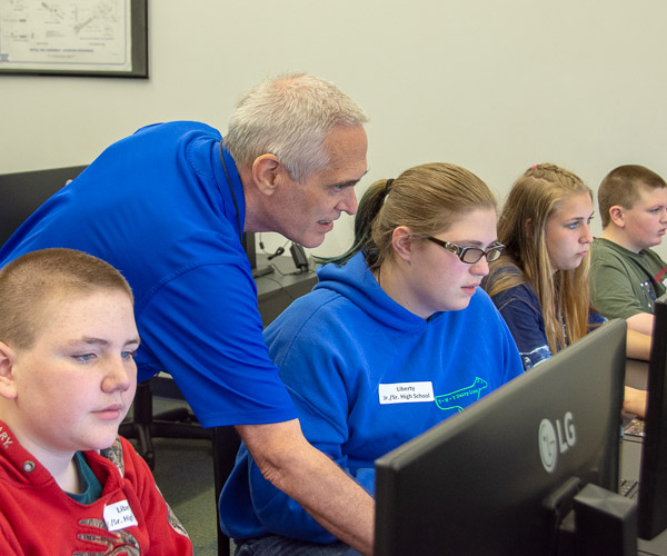 J.D. Mather, assistant professor of engineering design technology, lends a hand to students exploring the career and CAD software. The session was led by Katherine A. Walker, assistant professor of engineering design technology.