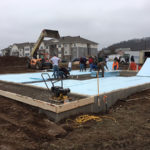 ... installing a layer of foam insulation prior to finishing the concrete work.