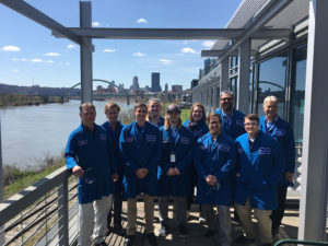 The Penn College plastics team at Braskem, in front of the Pittsburgh skyline