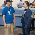 Johnson talks with an Open House attendee whose T-shirt indicates he's in the right place.