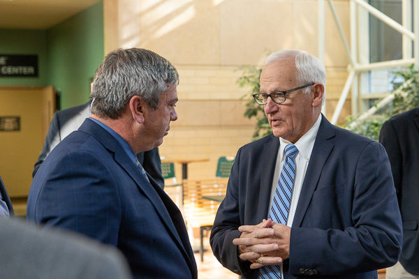 Always engaged and advocating for the college, Yaw (right) converses with Browne in the atrium of the Breuder Advanced Technology & Health Sciences Center. 