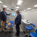 Hands-on exposure to the dental hygiene lab: Shawn A. Kiser, director of dental hygiene, shows Browne an X-ray that the senator took with the press of a button.