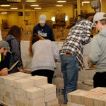 Highly visible in neon T-shirts, building construction technology majors Ian R. Myers (left), of Morrisdale, and James G. Vile Jr., of Sheffield, supervise several courses of brickwork.