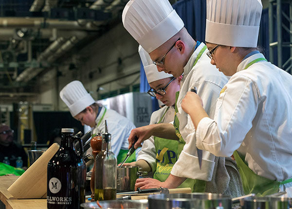 School of Business & Hospitality majors from Penn College take part in a Student Cooking Challenge at the 2018 Pennsylvania Farm Show. All six of the college’s academic schools will again be represented at the Jan. 5-12 event, the nation’s largest indoor agricultural expo. (Photo by Davey Rudy)