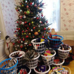 Overflowing gift baskets, bound for local YWCA residents, surround the facility's tree.