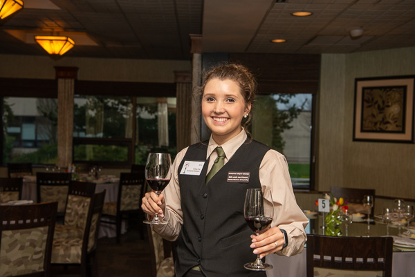 Ireland Q. Hastings, a 2019 Visiting Chef Scholarship recipient, tends to pre-dinner wine duties. Hastings is enrolled in hospitality management. 